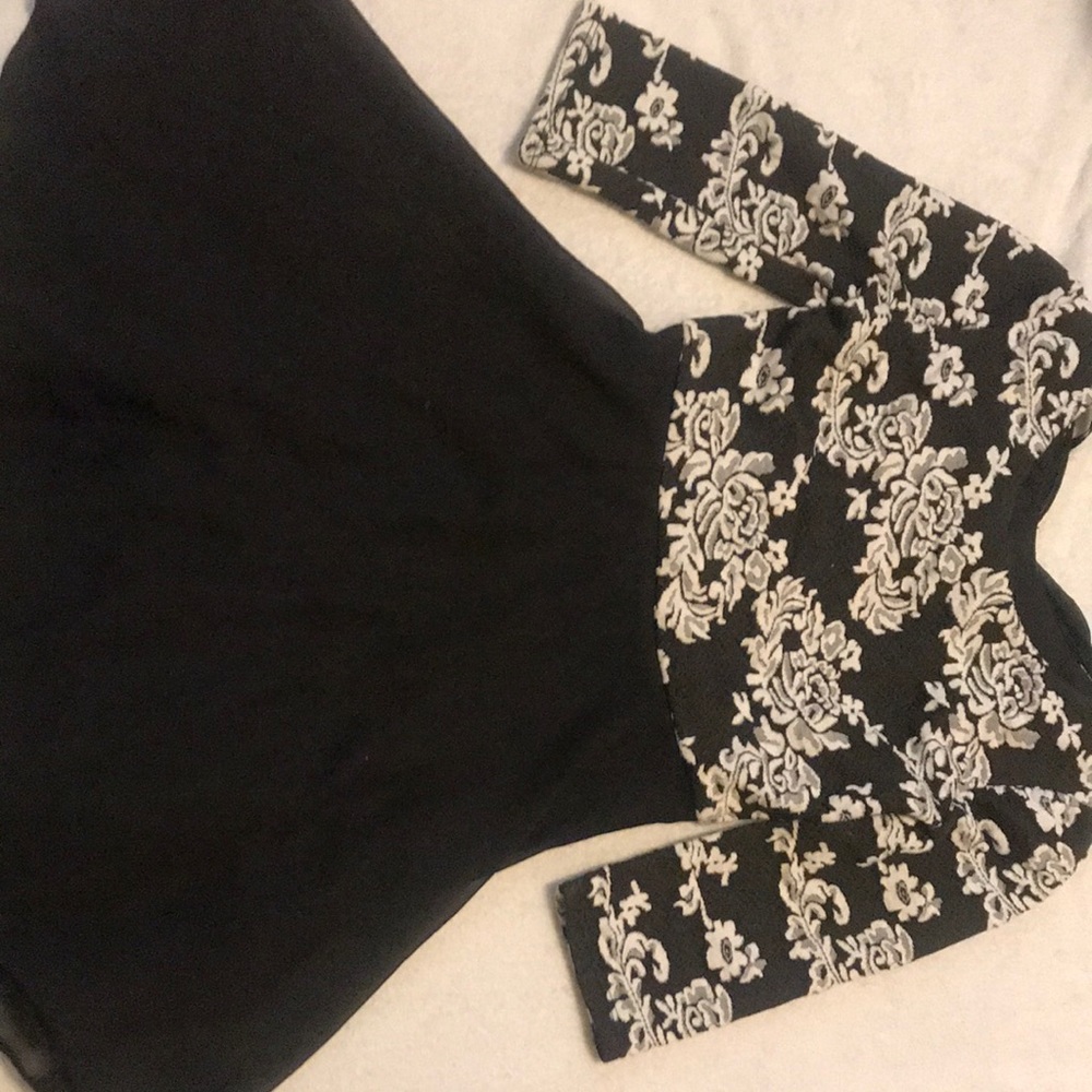 Black kids formal dress with white design at top.